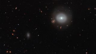 Captured by NASA/ESA's Hubble Space Telescope's Advanced Camera for Surveys (ACS), this scene shows PGC 83677, a lenticular galaxy — a type of galaxy that lies between the more familiar elliptical and spiral varieties.